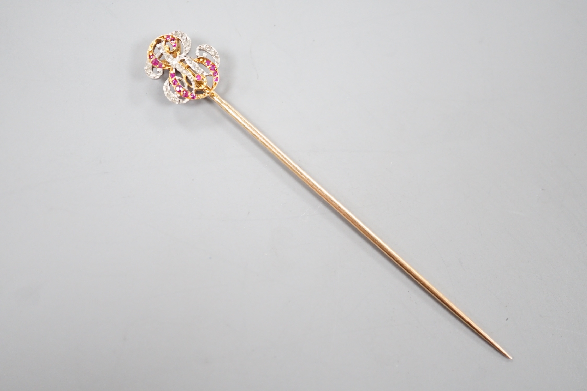 An early 20tyh century French yellow metal (18ct poincon mark) ruby and diamond set 'ER' monogram stick pin, 70mm, gross weight 2 grams, in Sewell of Berkeley Square red leather box.